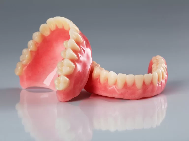 Custom-made full dentures for upper and lower jaws, designed for natural appearance and function